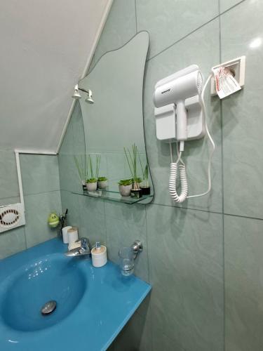 a bathroom with a blue sink and a mirror at TARA RIVER HOUSE in Odžića Glavica