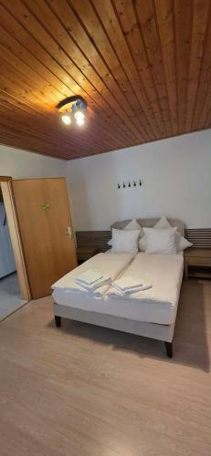 a bed in a room with a wooden ceiling at Haus Sofia in Cochem