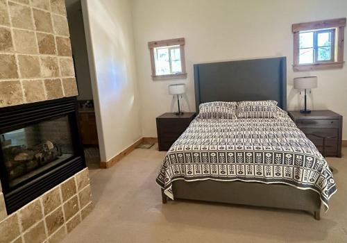 a bedroom with a bed and a fireplace at Cozy Light Filled Truckee Downtown in Truckee