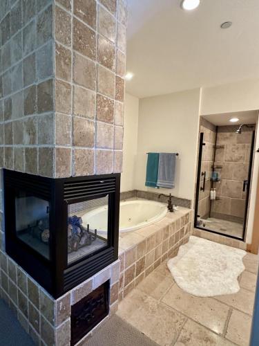 a bathroom with a fireplace and a bath tub at Cozy Light Filled Truckee Downtown in Truckee