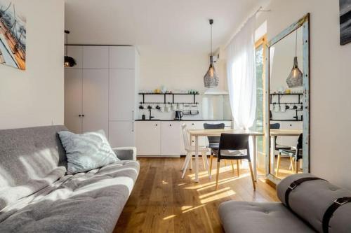 a living room with a couch and a table with chairs at Pino Home in Neringa