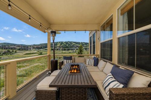 a balcony with a couch and a fire pit at 100 Fairway Lane in Granby