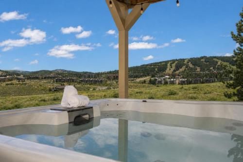 a swimming pool with a view of a mountain at 100 Fairway Lane in Granby