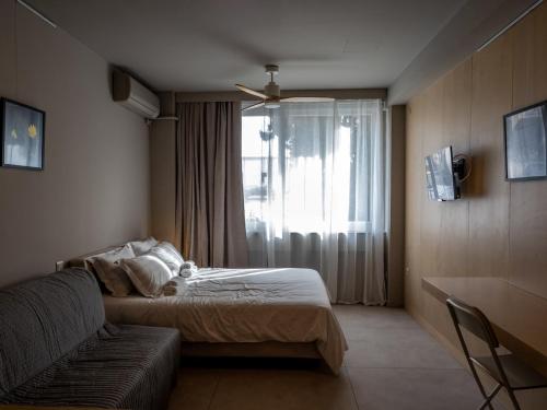 a hotel room with a bed and a window at Downtown photographer's studio in Korinthos