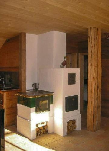 a kitchen with a stove in the middle of a room at Mountain House With Sauna In Sachrang in Sachrang
