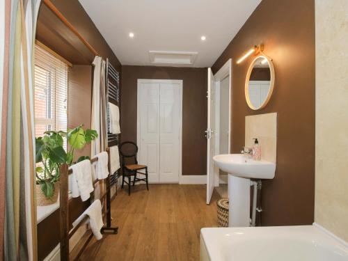 a bathroom with a sink and a mirror at Little Pentwyn in Hereford