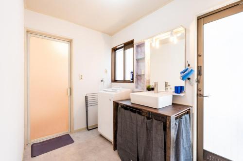 a bathroom with a sink and a mirror at Ninja Village - Miyajima in Hatsukaichi