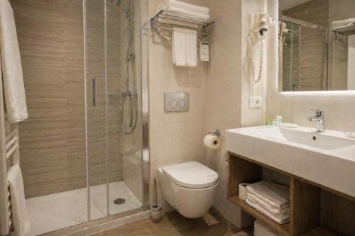 a bathroom with a shower and a toilet and a sink at Casa Velvet in Madrid