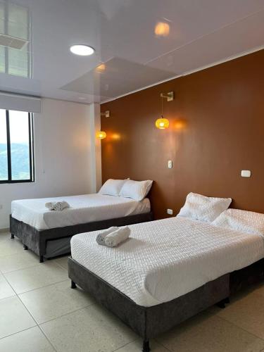 a room with two beds in a room at Casa Lemora in Vergara