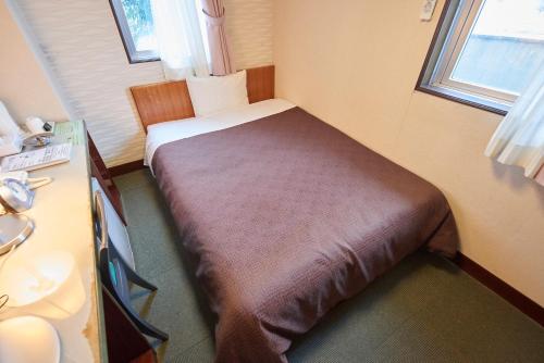 Un pat sau paturi într-o cameră la Hotel Select Inn Nishinasuno
