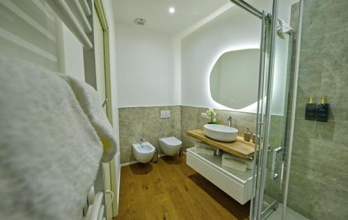 a bathroom with a sink and a toilet at NS Urban Suite in Udine