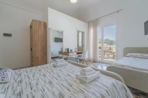 a bedroom with a large bed with towels on it at Ponente & Maestro Rooms in Favignana