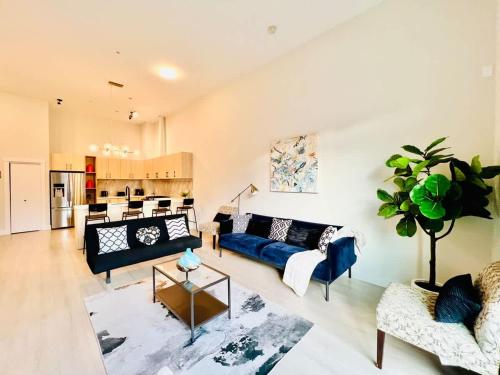 a living room with a blue couch and a table at Family Friendly Ground Level Condo in Surrey