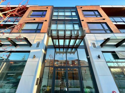 a tall building with glass windows on it at Family Friendly Ground Level Condo in Surrey