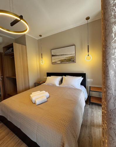 a bedroom with a bed with two towels on it at Gregory Central Apartment in Chania