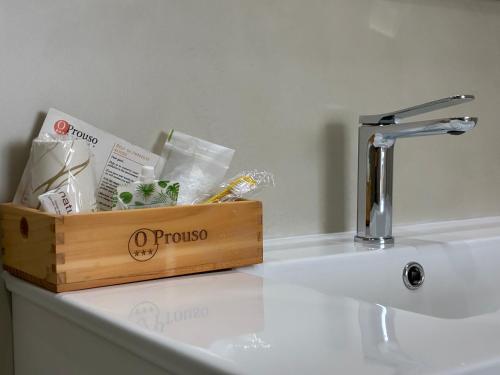 a wooden box sitting on top of a bathroom sink at Pensión O Prouso in San Mamede de Carnota
