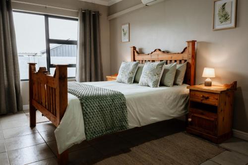 a bedroom with a large bed and a window at Melk en Heuning Uitspan in Orania