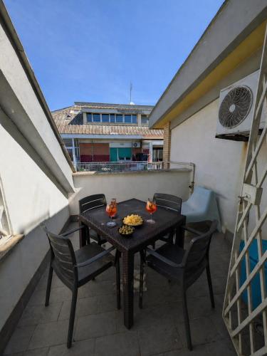 a table and chairs on the balcony of a building at ESPRESSO VISTA MARE, Ostia Antica in Lido di Ostia