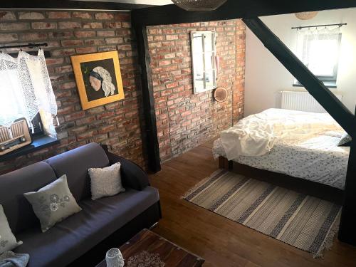 a living room with a bed and a couch at Dobków 42 in Dobków