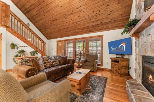 a living room with a couch and a fireplace at SBL14 -Mayberry Lodge in Branson West