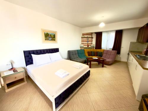 a hotel room with a bed and a couch at Vila Bilali in Ksamil