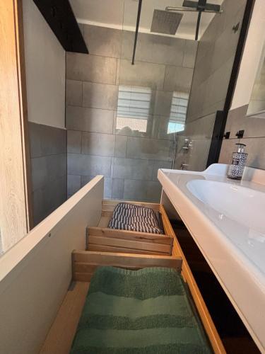 a bathroom with a bath tub and a sink at Panoramablick am Herzoghof in Obing