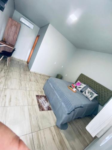 a bedroom with a bed and a couch at PousadaOasis in Várzea Grande