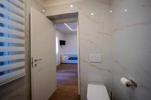 a bathroom with a toilet and a room with a bed at Carlo's Luxury Villa in Agerola