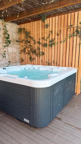 a jacuzzi tub sitting next to a wooden wall at Caniçada Home in Vieira do Minho