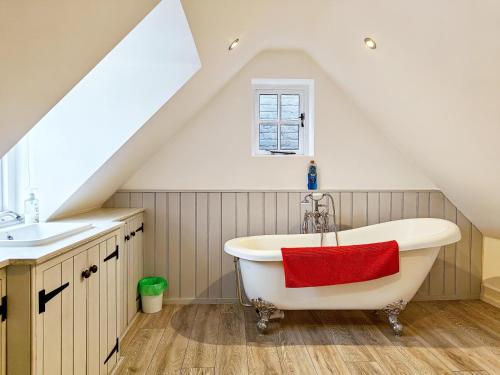 a attic bathroom with a tub and a sink at 4 Bed in Lymington oc-c41423 in Lymington
