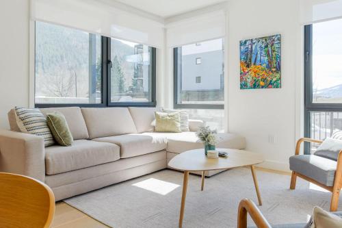 a living room with a couch and a table at Summit Central in Revelstoke