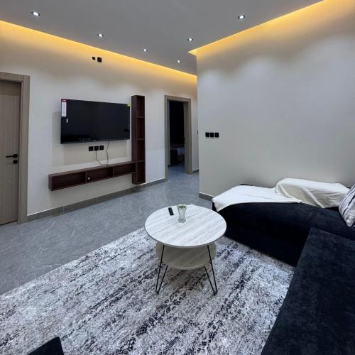 a living room with a couch and a table at Misk Apartment in Jeddah