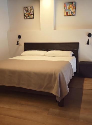 a bedroom with a large bed with white sheets and pillows at NaturalmenteLucia in Cologno al Serio