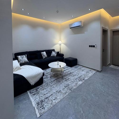 a living room with a couch and a table at Misk Apartment in Jeddah