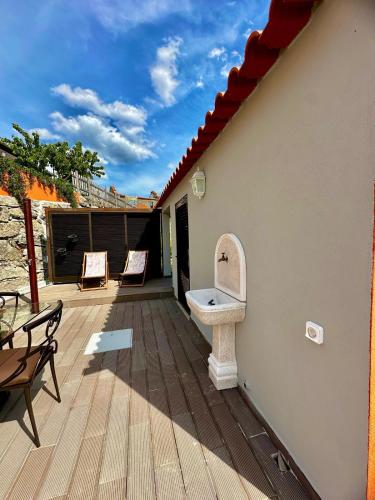 a deck with a sink on the side of a house at Quinta Santo Antonio in Gouveia