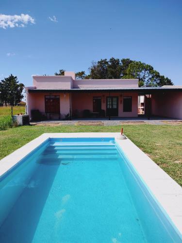 a swimming pool in front of a house at Casona Villa Helena in Miramar