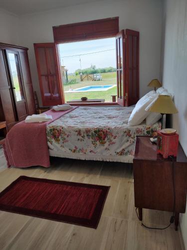 a bedroom with a bed and a large window at Casona Villa Helena in Miramar