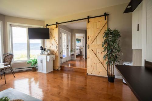 a sliding barn door in a living room with a kitchen at Panoramic Acres B & B - Lake & Mountain Views in Vernon