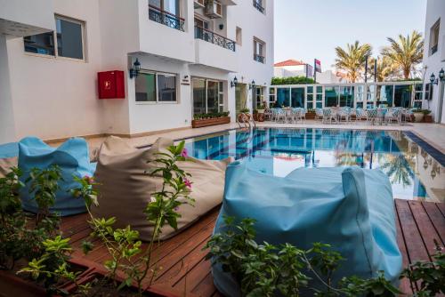 a pool at a hotel with chairs around it at Swiss Wellness Boutique Hotel Hurghada in Hurghada