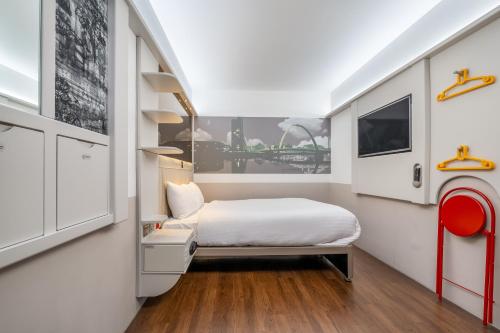 a small bedroom with a bed and a window at Point A Hotel Glasgow in Glasgow