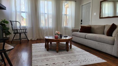 a living room with a couch and a coffee table at This Old House in Detroit