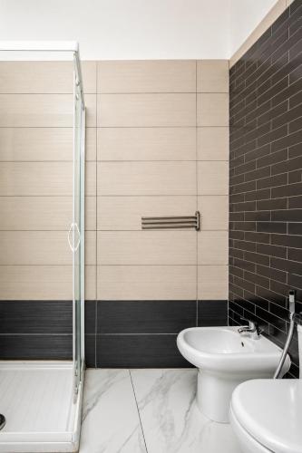 a bathroom with a shower and a toilet and a sink at Neve Al Sole Modern Suites near Metro Materdei in Naples Center in Naples