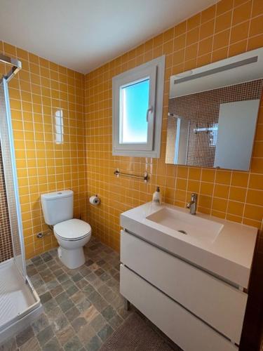 a bathroom with a toilet and a sink and a shower at Casa papillon in Outeiro