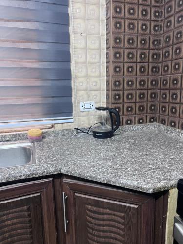 a kitchen counter with a phone on top of it at Saeeds apartment in Ajloun