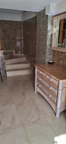 a room with stairs and a dresser and a table at Casa del Sol Miramar in Miramar