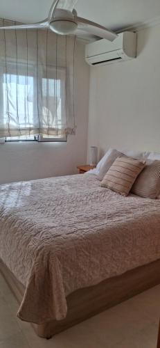 a bedroom with a large bed and a window at Casa del Sol Miramar in Miramar