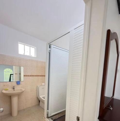 a bathroom with a shower and a toilet and a sink at Muikora Albion in Albion