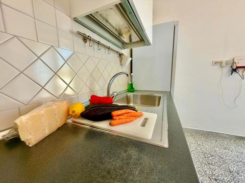 a kitchen counter with vegetables on a cutting board at My Shazzy with amazing Sea View terrace in Praiano