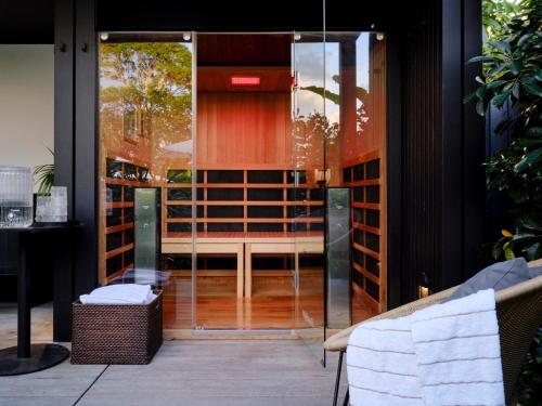 a glass door leading into a room with a table at The Hide Byron Bay in Byron Bay