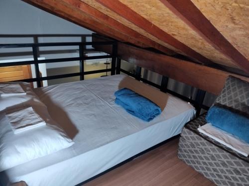 a bedroom with a bed and a chair in a room at Loft completo com HIDRO e piscina próx à praia in Caraguatatuba